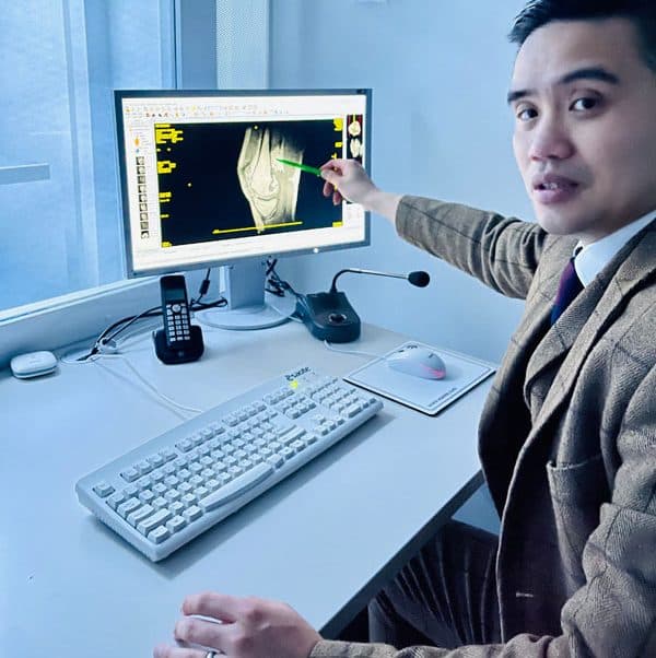 Specialist reviewing knee imaging on screen